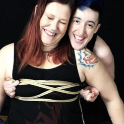 One person tying up the chest of another person.